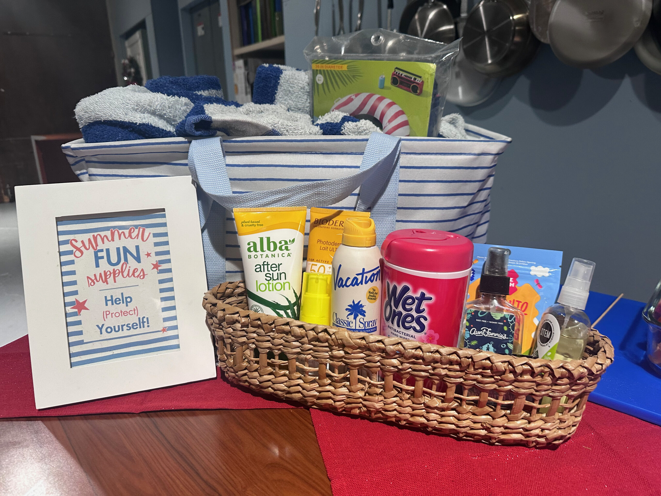 Sunscreen and Bug Spray Station Party Idea with Sign that Says Help Protect Yourself in US Patriotic Colors