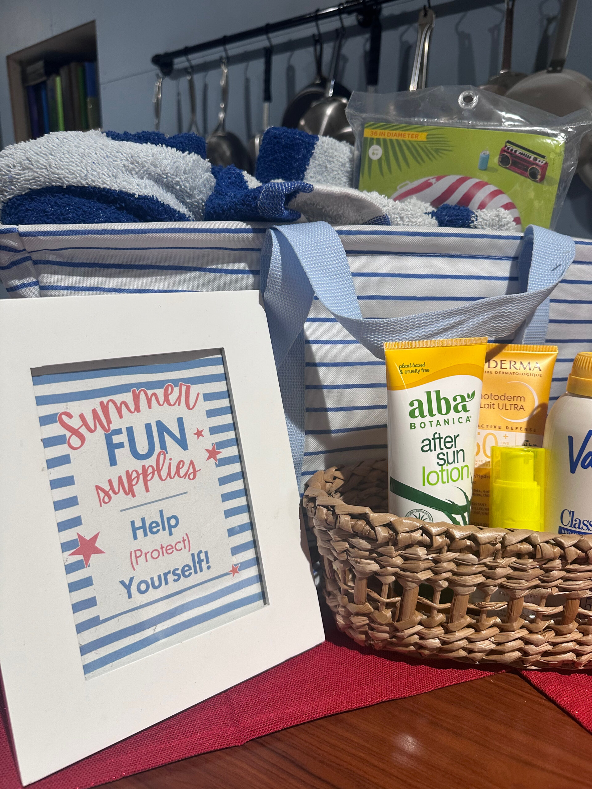 display of summer party items including towels sunscreen and floaties