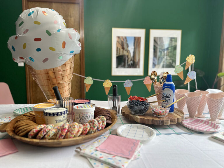 party set up with ice cream sandwich bar, ice cream sundae bar, and ice cream decor items