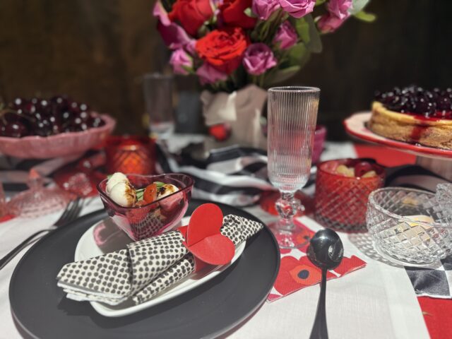 Valentine's Day Tablescape with layered prints of black and white dots, black and white stripes, and checkers. 